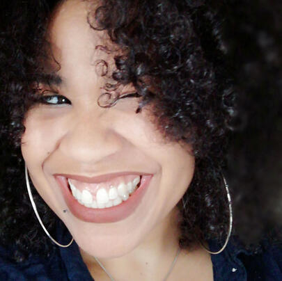 woman with curly hair smiling